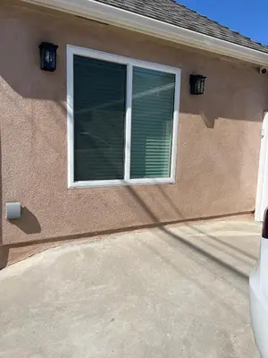 a house with a window with a shutter at Private guest cottage in Long Beach