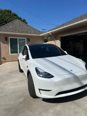 a white car parked in front of a house at Private guest cottage in Long Beach