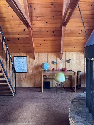a room with a desk in a wooden ceiling at A-Frame with Carousel Fireplace in Running Springs