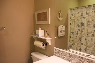 a bathroom with a toilet and a shower curtain at Pretty Relaxed Me in Brea