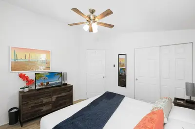 a bedroom with a bed and a ceiling fan at Disney Beaches Close Fire Pit Stadiums in Norwalk