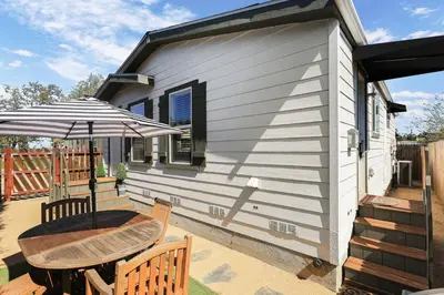 a small house with a table and an umbrella at Disney Beaches Close Fire Pit Stadiums in Norwalk