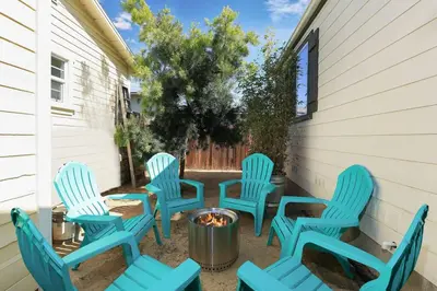 a group of blue chairs sitting around a fire pit at Disney Beaches Close Fire Pit Stadiums in Norwalk