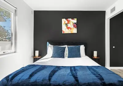a bedroom with a large bed with blue and white at Love & LuxuryHeart Shaped Pool Paradise in Los Angeles