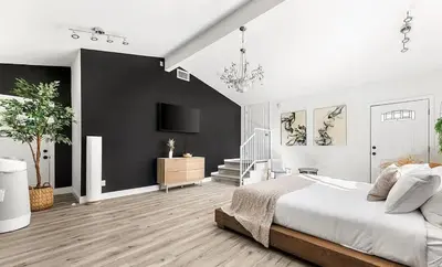 a white bedroom with a large bed and a staircase at Love & LuxuryHeart Shaped Pool Paradise in Los Angeles