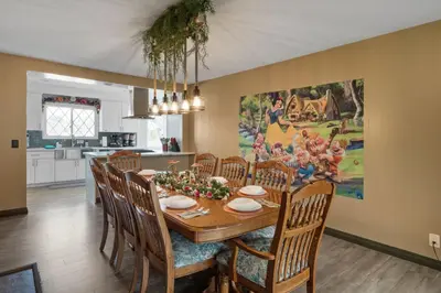 a kitchen and dining room with a table and chairs at Princess Palace by OC Adventure Homes in Anaheim