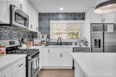 a kitchen with white cabinets and a stove top oven at Sunny Simi Valley Valley 4BR 3BR LTR Modern Home Dedicated Work Place High Speed internet in Simi Valley