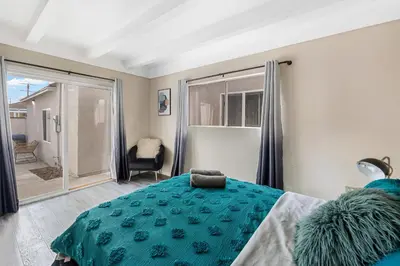 a bedroom with a bed and a sliding glass door at Comfy Home Near Sofi Stadium 2 in Los Angeles