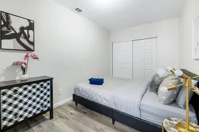 a bedroom with a bed and white walls at Comfy Home Near Sofi Stadium 2 in Los Angeles