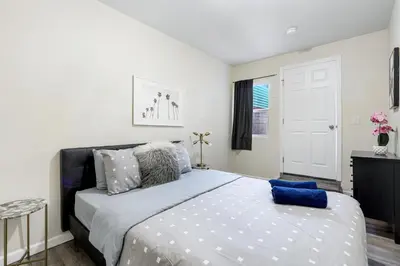 a bedroom with a large bed with blue pillows at Comfy Home Near Sofi Stadium 2 in Los Angeles