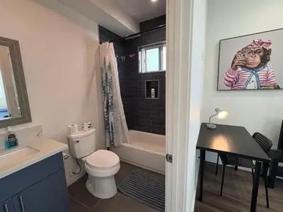 a bathroom with a toilet and a sink and a shower at Blue Central Stay Near USC, BMO Stadium & Downtown LA in Los Angeles