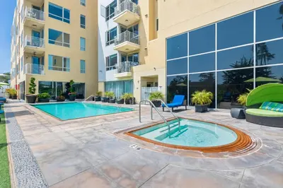 a pool in the courtyard of a building with a building at The Heart Of Hollywood Hills in Los Angeles