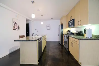 a large kitchen with wooden cabinets and counter tops at The Heart Of Hollywood Hills in Los Angeles