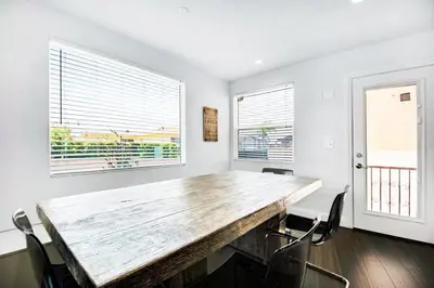 a dining room with a wooden table and chairs at House in the Hills in Los Angeles