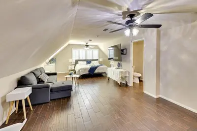a living room with a couch and a ceiling fan at 4 Mi to Dtwn Riverside Gem with Pool and Game Room in Riverside