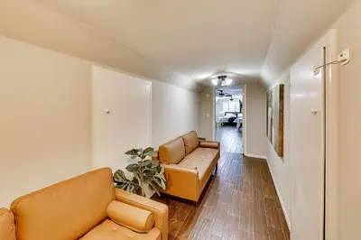 a living room with two couches and a hallway at 4 Mi to Dtwn Riverside Gem with Pool and Game Room in Riverside