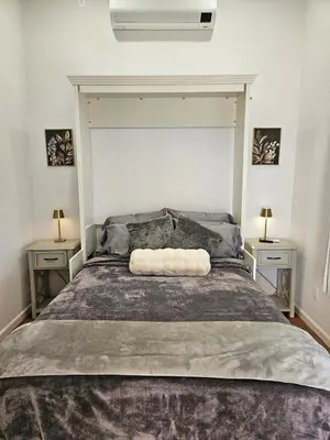 a bedroom with a large bed with two night stands at Modern 1-bedroom Studio with Full Kitchen and Bath in Santa Clarita