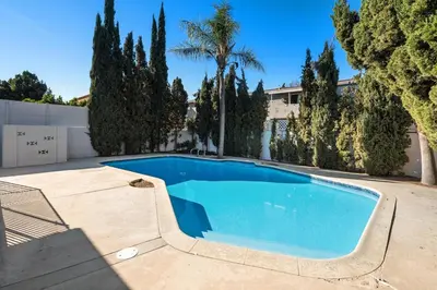 a swimming pool in a yard with trees at House with pool in prime location - 10 mins to Universal Studio in Garnsey