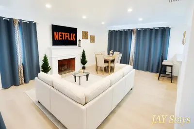 a living room with a white couch and a table at Newly renovated, warm home with 4 bedrooms, 14 miles from Disney in Whittier