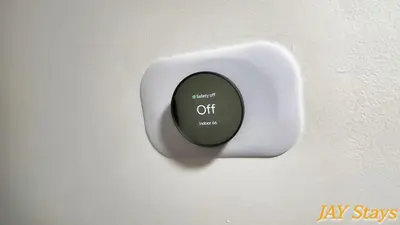 a white switch with a green light on a wall at Newly renovated, warm home with 4 bedrooms, 14 miles from Disney in Whittier