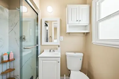 a bathroom with a toilet and a sink and a shower at Modern 4B Retreat with Cozy Decor in Upland