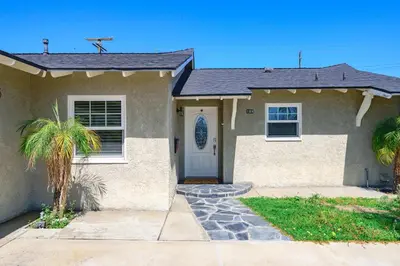 a house with a palm tree in front of it at Modern 4B Retreat with Cozy Decor in Upland