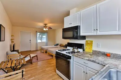 a kitchen with a stove and a living room at Amazing Escape near LA Meditation Room, Game room, Hot Tub, Pool in Leona Valley