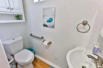 a white bathroom with a toilet and a sink at Amazing Escape near LA Meditation Room, Game room, Hot Tub, Pool in Leona Valley