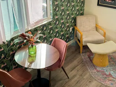 a dining room with a table and a chair at Forty First Place - Boutique Hostel in Los Angeles