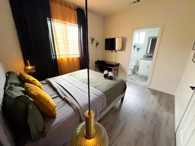 a bedroom with a bed and a mirror at Forty First Place - Boutique Hostel in Los Angeles