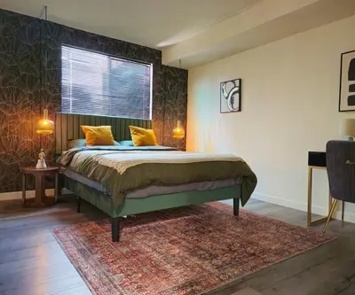 a bedroom with a bed with yellow pillows and a window at Forty First Place - Boutique Hostel in Los Angeles
