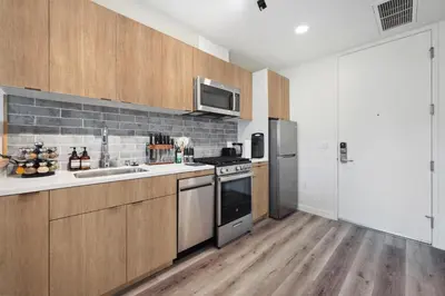 a kitchen with wooden cabinets and a stove top oven at Hollywood 1bdr apt with Pool, Free Parking, Gym in Los Angeles