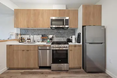 a kitchen with a stainless steel refrigerator and a microwave at Hollywood 1bdr apt with Pool, Free Parking, Gym in Los Angeles