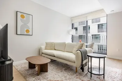 a living room with a couch and a tv at Blueground Downtown elevator nr parks LAX-1251 in Los Angeles