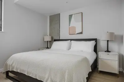a bedroom with a white bed and two lamps at Blueground Downtown AC elevator nr parks LAX-1253 in Los Angeles