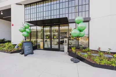 a group of green balloons in front of a building at Blueground Downtown AC elevator nr parks LAX-1253 in Los Angeles
