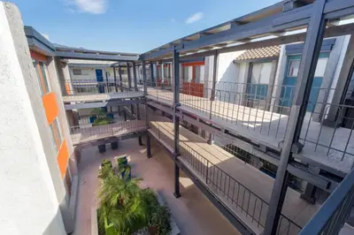 an overhead view of a balcony of a building with benches at Blueground Glendale pool AC nr Americana LAX-1319 in Glendale