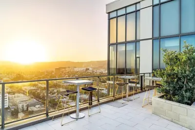 a balcony with tables and chairs on a building at The Sky Gem in Los Angeles