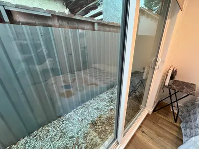 a sliding glass door of a balcony with a room at Los Angeles Central Town House in Los Angeles