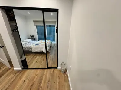 a mirror in a room with a bed and a bedroom at Los Angeles Central Town House in Los Angeles