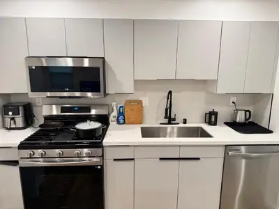 a white kitchen with a stove and a sink at Los Angeles Central Town House in Los Angeles