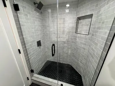 a shower with a glass door and a tile shower at Los Angeles Central Town House in Los Angeles