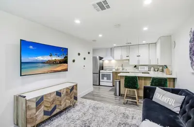 an open kitchen and living room with a tv on the wall at Wellness Temple LA in Tarzana