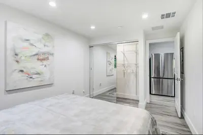 a white room with a bed and a refrigerator at Wellness Temple LA in Tarzana