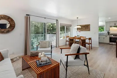 a living room with a couch and a table at Coastal Living and Family Friendly in Summerland