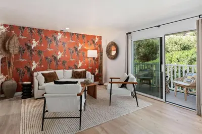 a living room with a couch and a table at Coastal Living and Family Friendly in Summerland