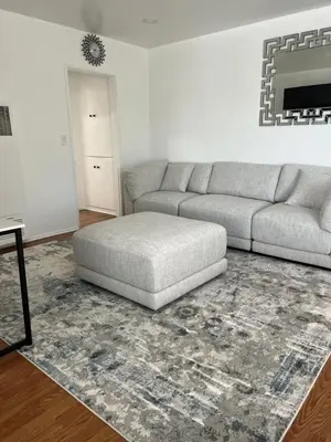 a living room with a couch and a rug at Sunny Franklin Place in Los Angeles