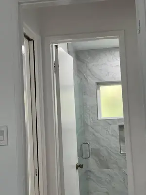 a bathroom with a shower with a glass door at Sunny Franklin Place in Los Angeles