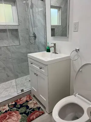 a bathroom with a shower and a toilet and a sink at Sunny Franklin Place in Los Angeles