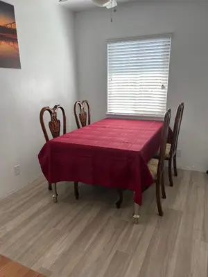 a dining room table with a red table cloth on it at Sunny Franklin Place in Los Angeles